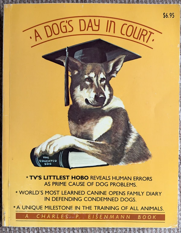 Yellow cover showing a German Shepherd in a mortarboard, resting its paws on a book titled The Educated Dog.